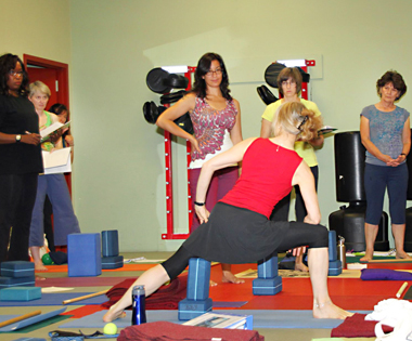 Jenny Otto in extended side angle at yoga therapy workshop