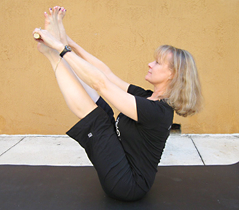 Jenny Otto boat pose with pole