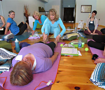 Jenny Otto demonstrates yoga therapy adjustment